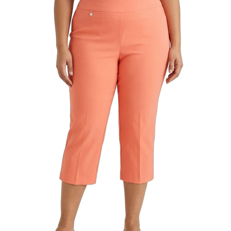 A model wearing a pair of coral orange cropped pants, styled with a white top and tan slide sandals, shown against a plain white background.