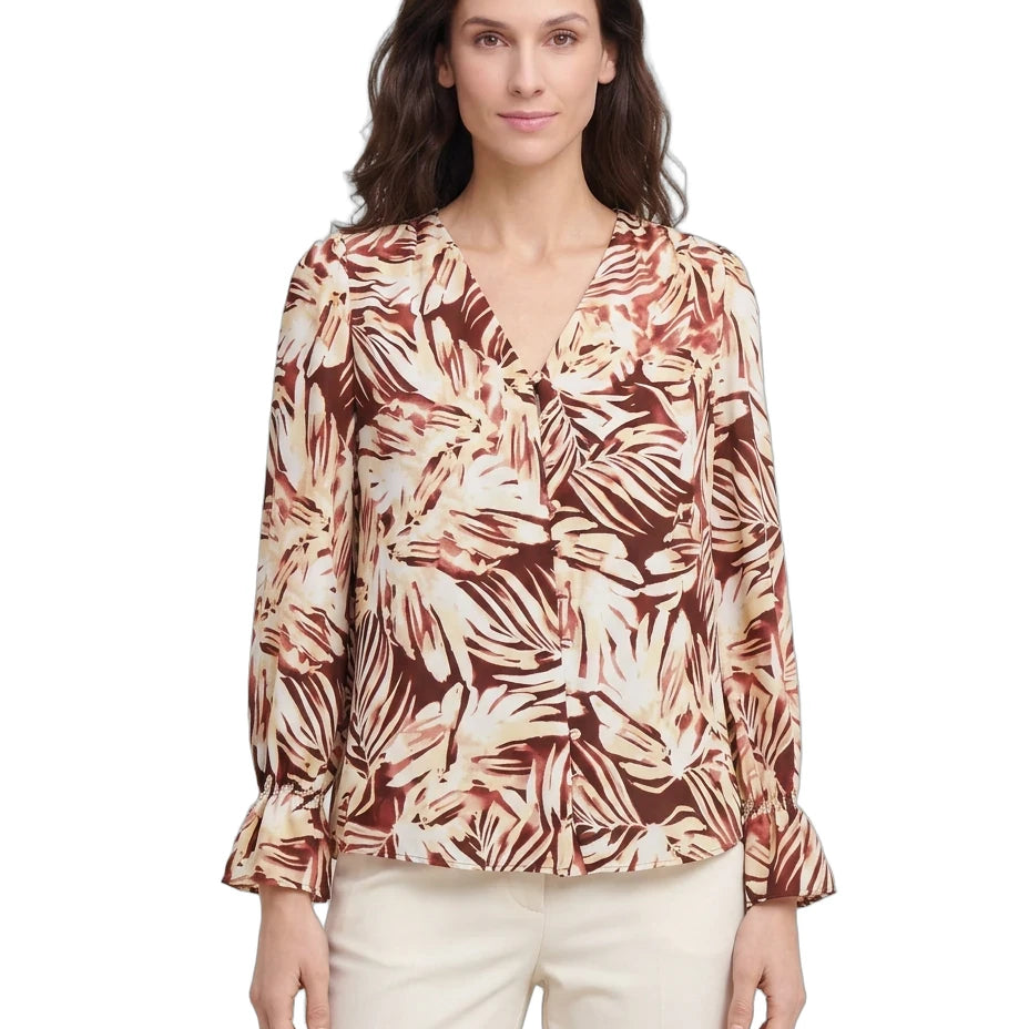 Woman wearing a patterned blouse on a white background