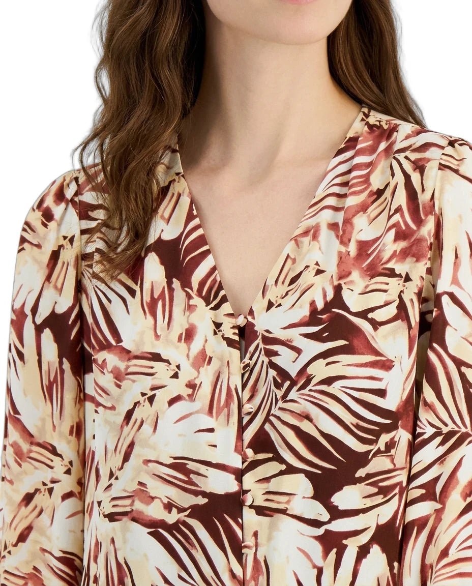 Woman wearing a floral patterned blouse with a plain background