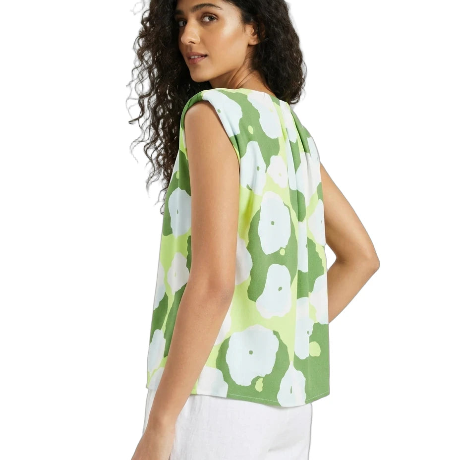 Woman wearing a green floral sleeveless top on a white background