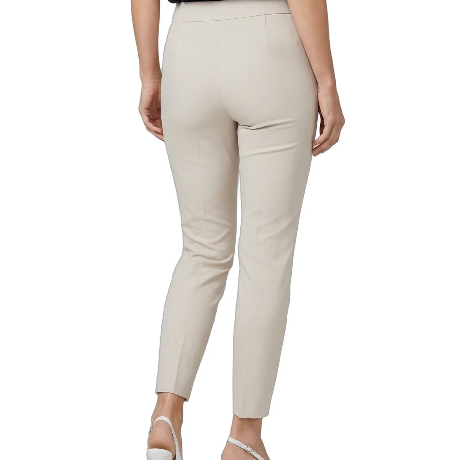 A model shown from the back wearing high-waisted, light beige cropped trousers, a navy blue top, and white slingback heels against a plain white background.
