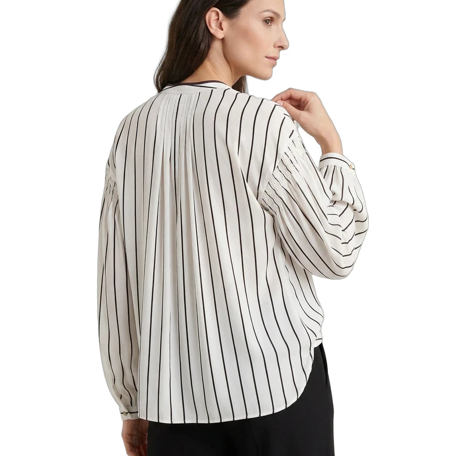 Woman wearing a striped blouse with long sleeves on a white background