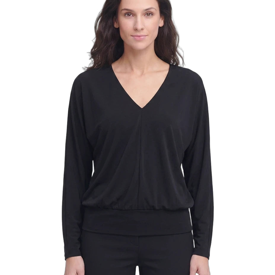 Woman wearing a black long-sleeve top on a white background