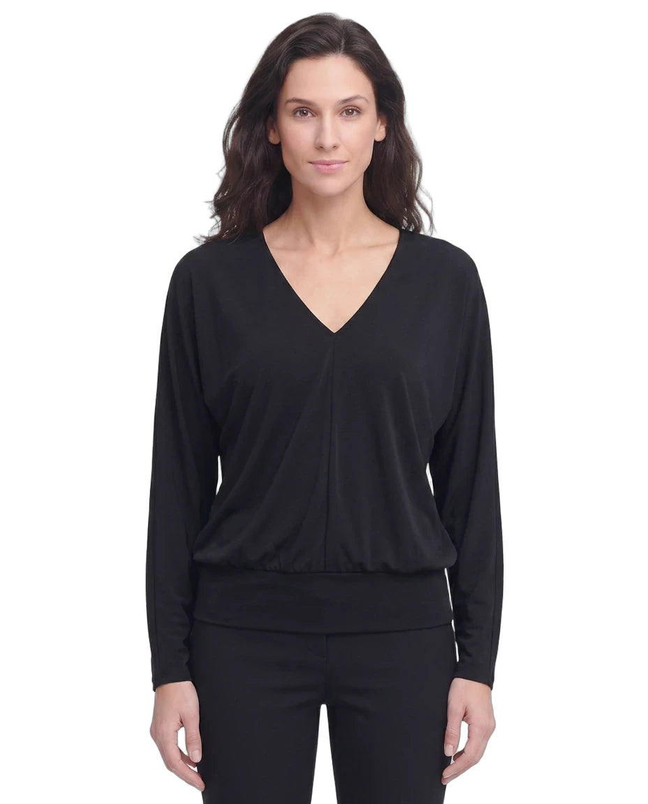 Woman wearing a black long-sleeve top on a white background