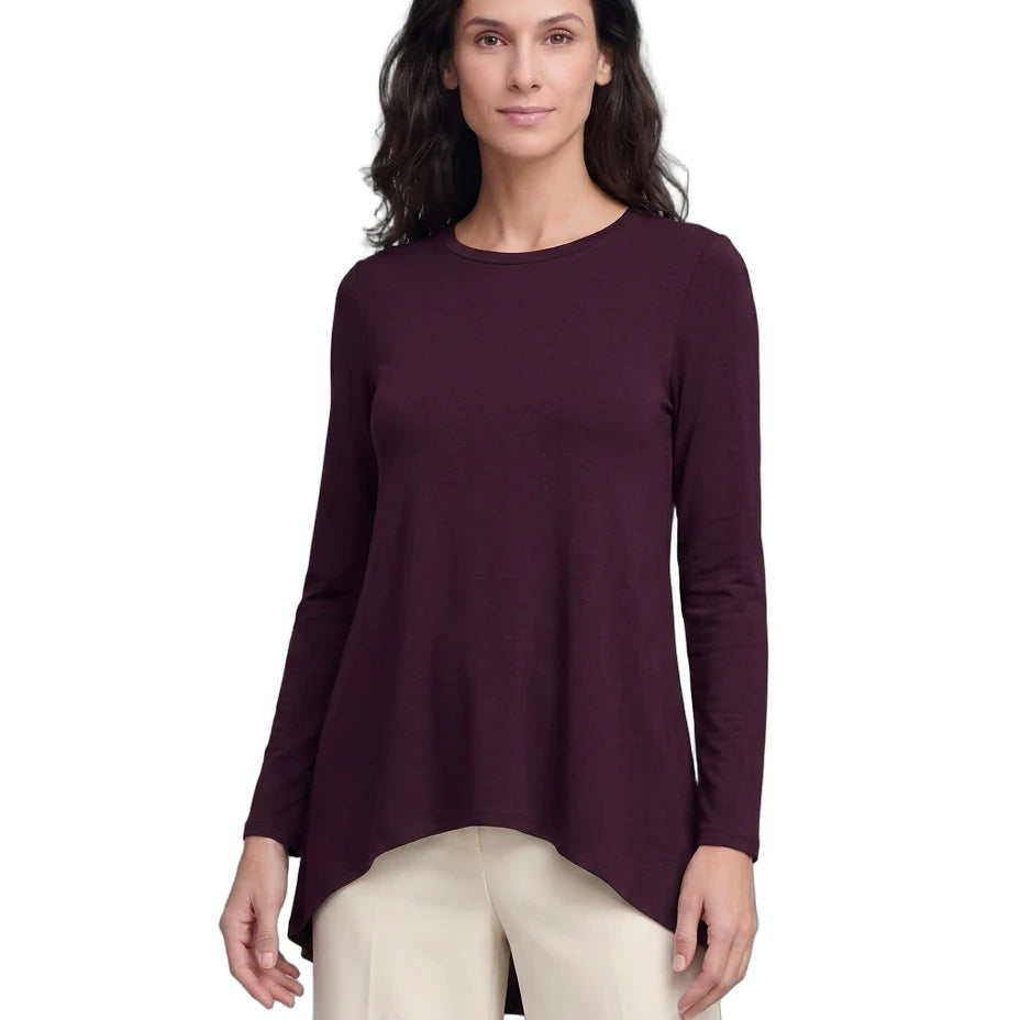 A woman modeling a long-sleeve high-low top in deep burgundy, paired with light beige pants, against a plain white background.