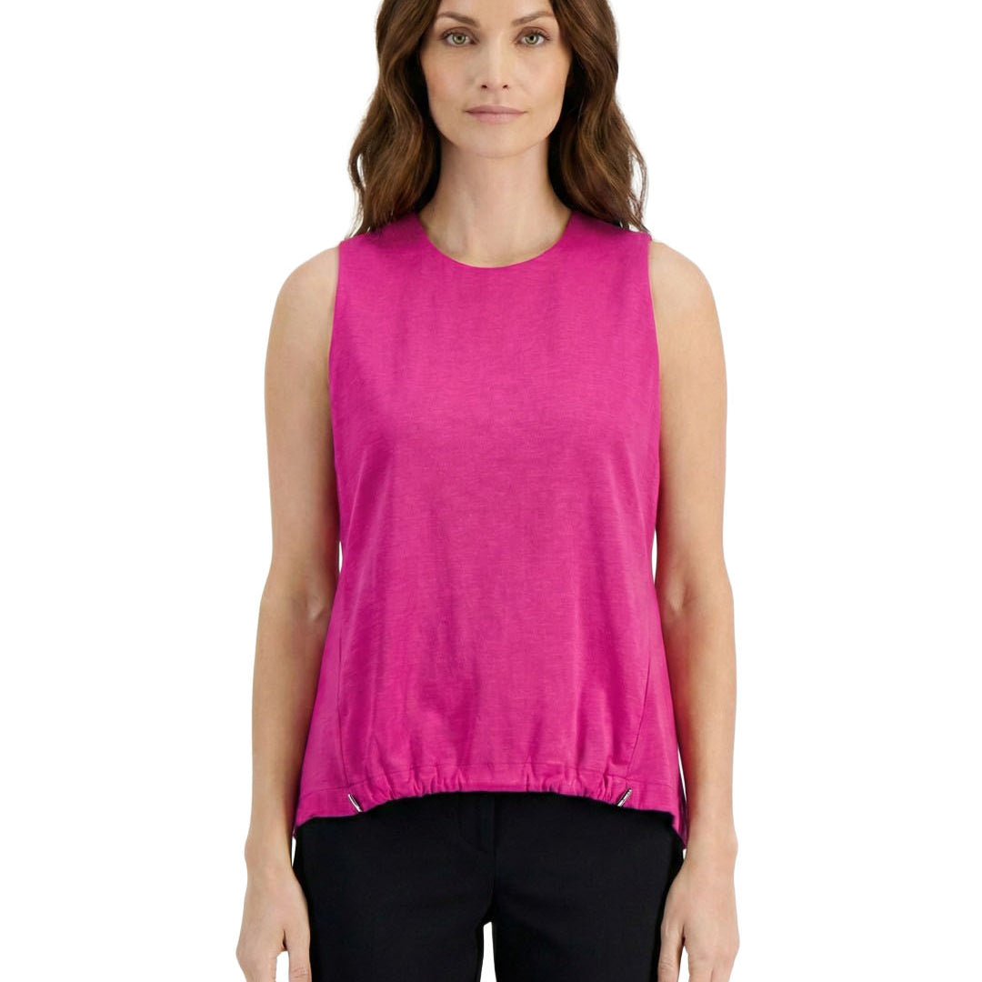 Woman wearing a bright pink sleeveless top on a white background