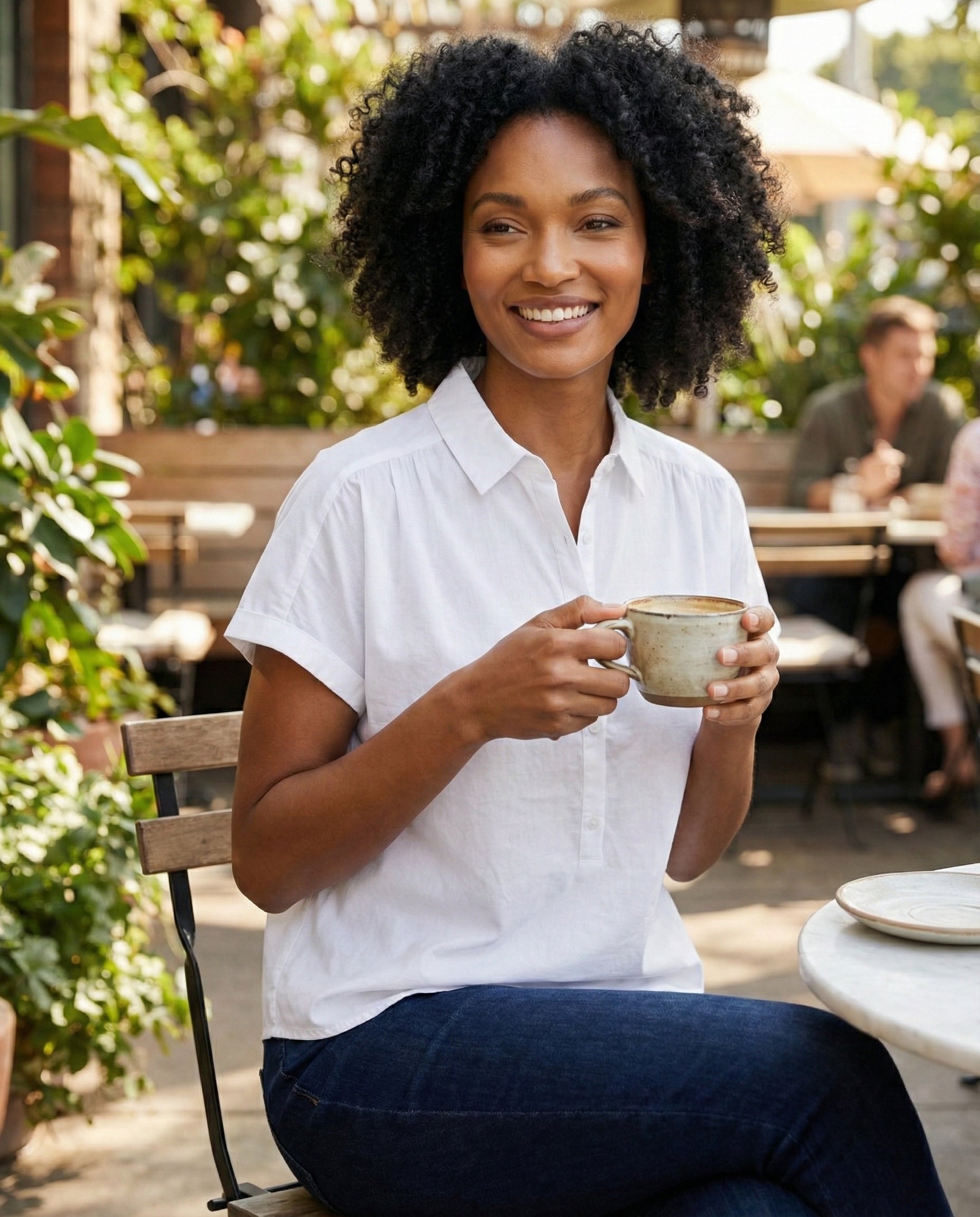 Woman holding a mug outdoors in a casual setting