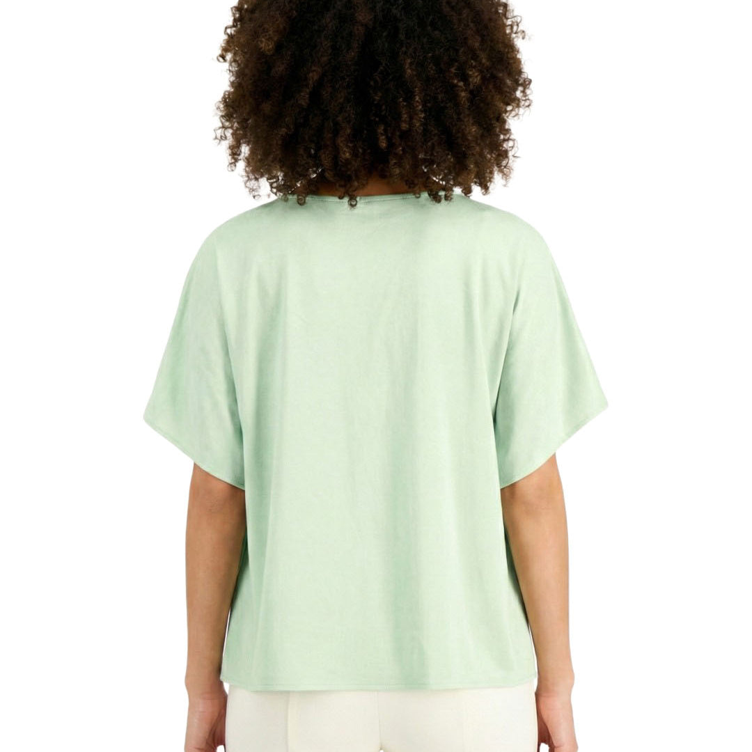 Person wearing a light green t-shirt on a white background