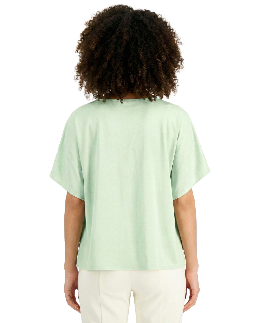 Person wearing a light green t-shirt on a white background
