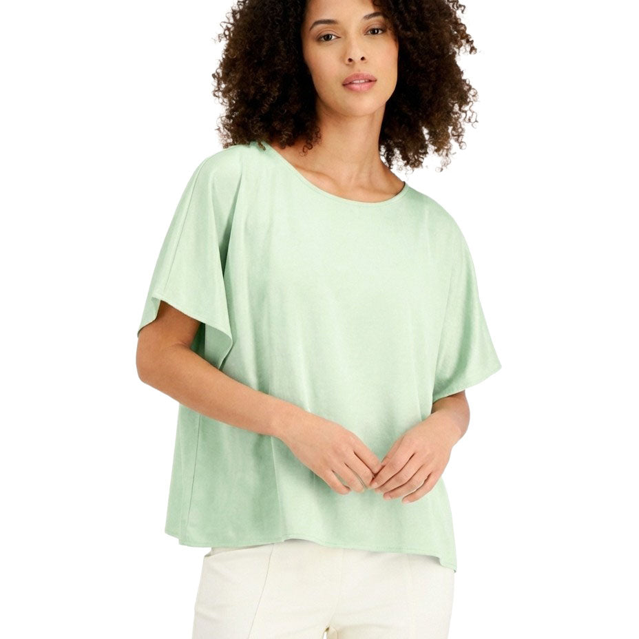 Woman wearing a light green blouse on a white background