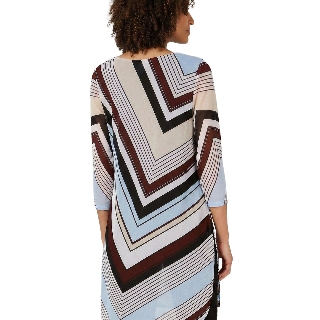 Woman wearing a patterned dress with a white background