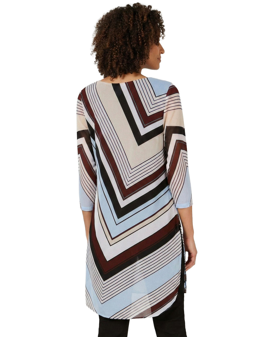 Woman wearing a patterned dress with a white background