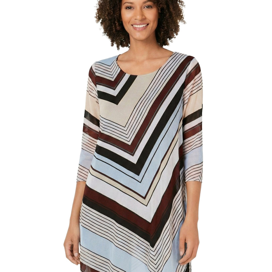 Woman wearing a long, patterned dress with a white background