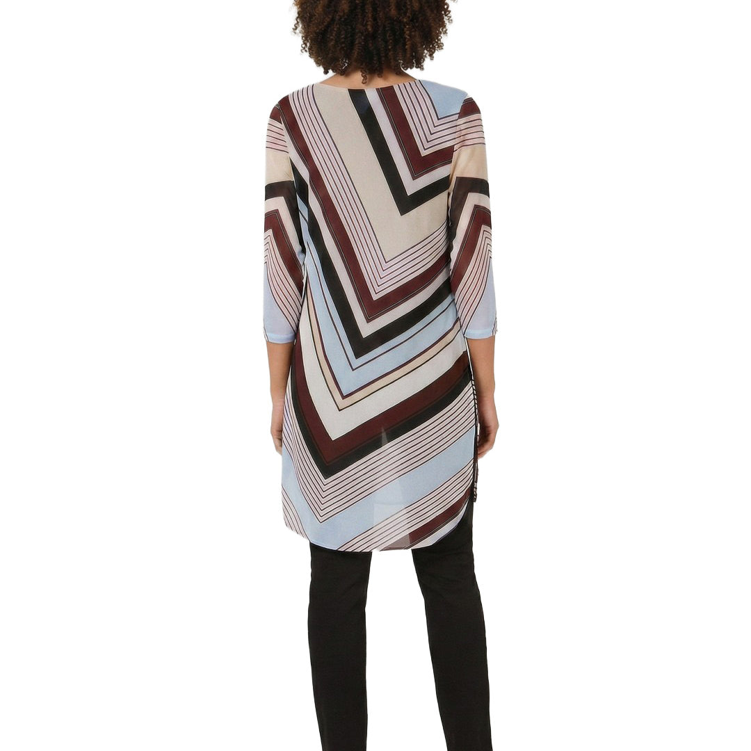 Person wearing a patterned tunic with a white background