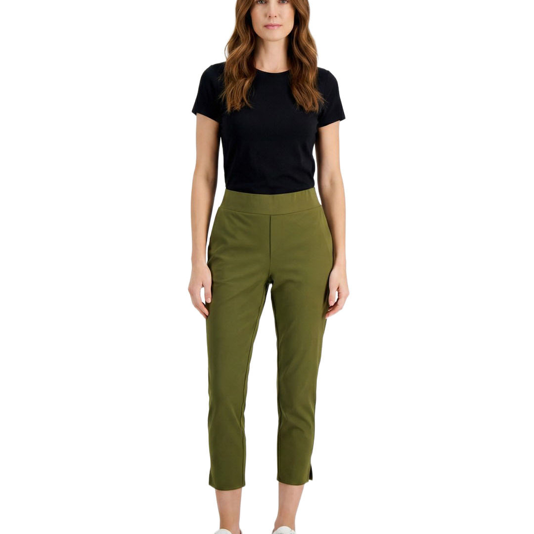 Woman wearing a black t-shirt and green pants on a white background