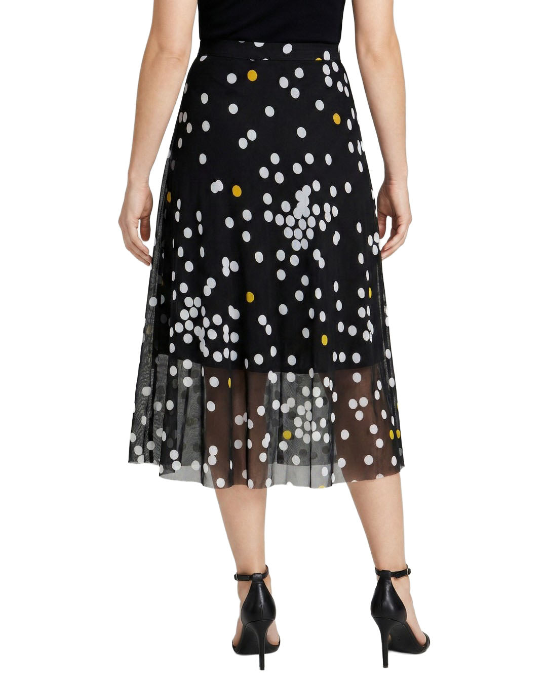Black skirt with white and yellow polka dots worn by a person on a white background