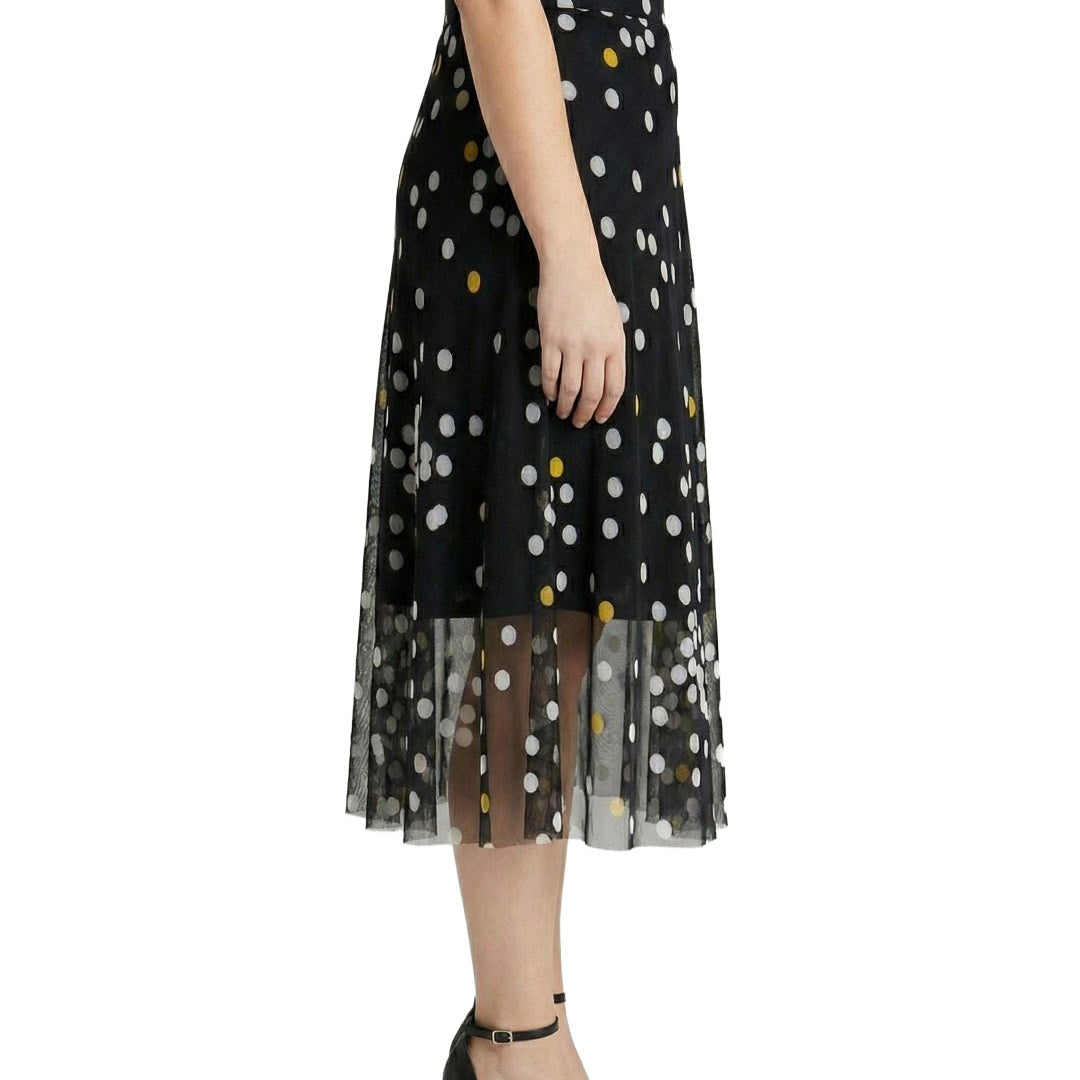 Black tulle skirt with white polka dots worn by a person on a white background