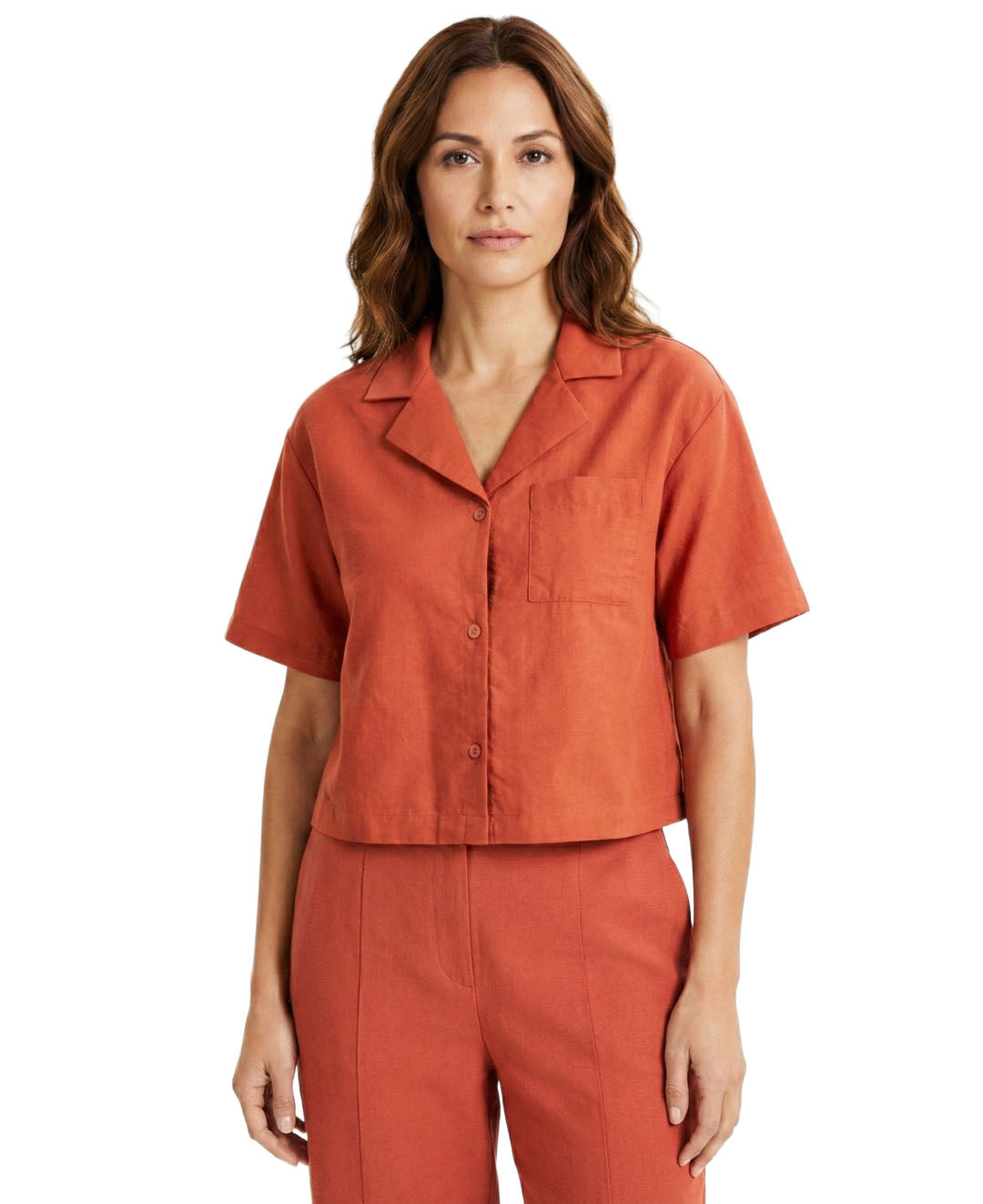 Woman wearing an orange short-sleeve shirt and pants on a white background
