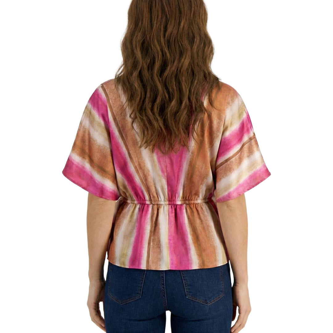 Woman wearing a colorful striped shirt and blue jeans on a white background
