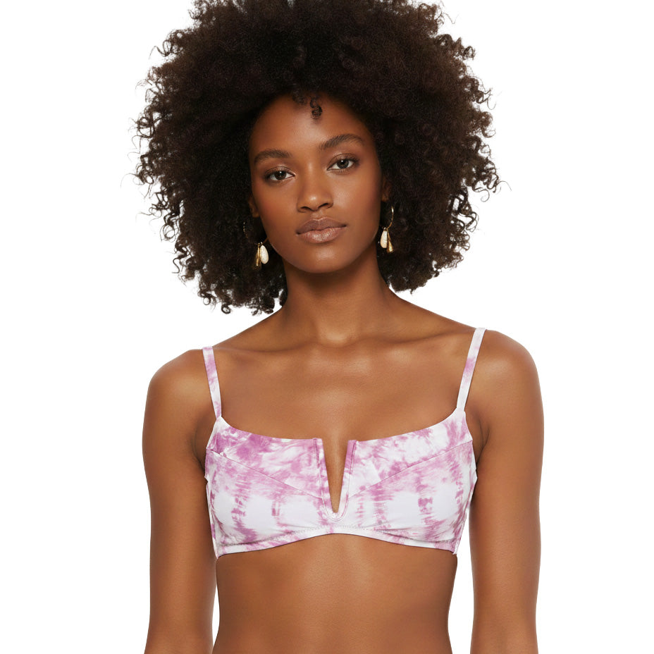 Woman wearing a pink tie-dye bikini top on a white background