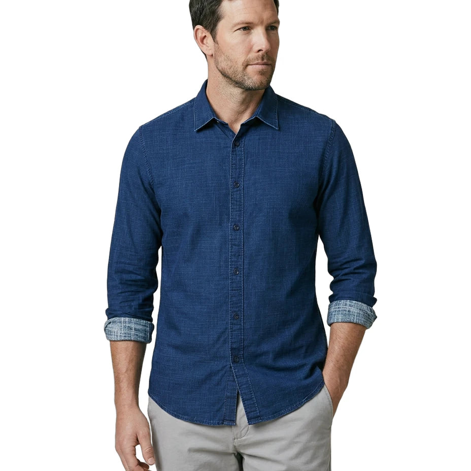 Man wearing a blue button-up shirt with rolled-up sleeves on a white background