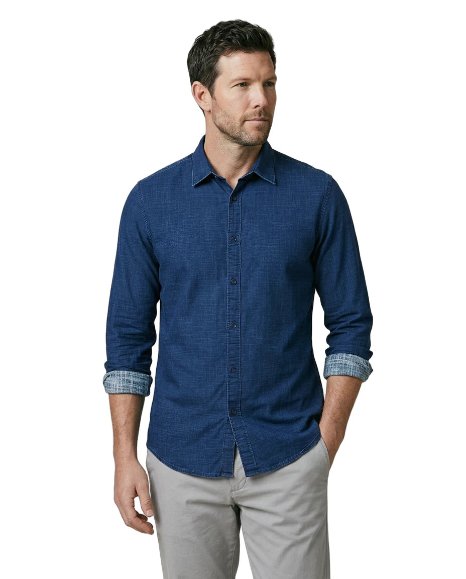 Man wearing a blue button-up shirt with rolled-up sleeves on a white background