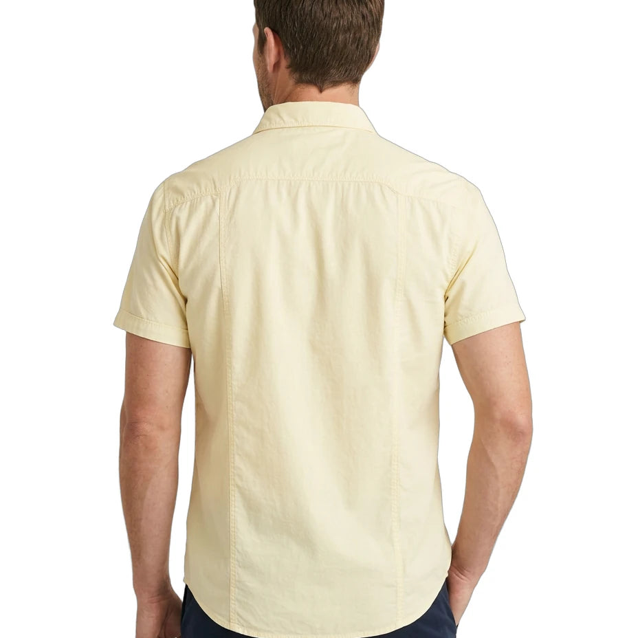 Man wearing a light yellow short-sleeve shirt on a white background