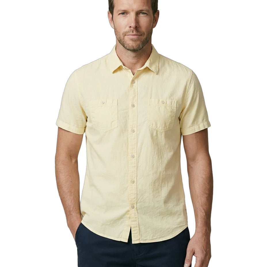Man wearing a light yellow short-sleeve shirt on a white background