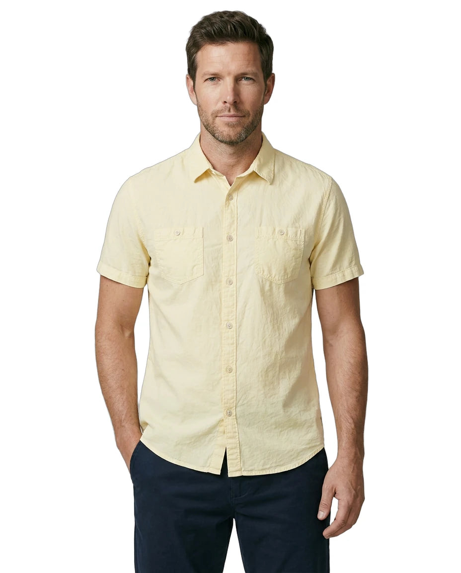 Man wearing a light yellow short-sleeve shirt on a white background