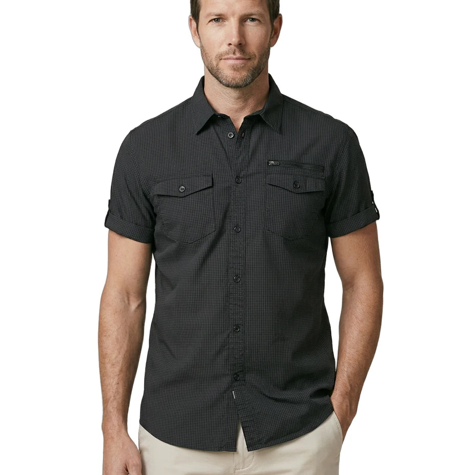 Man wearing a black short-sleeve shirt with pockets on a white background