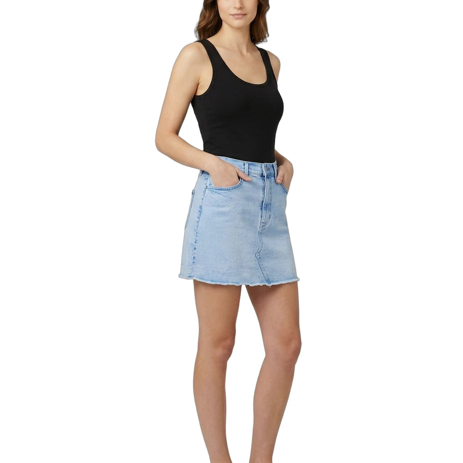 Woman wearing a black tank top and light blue denim skirt on a white background