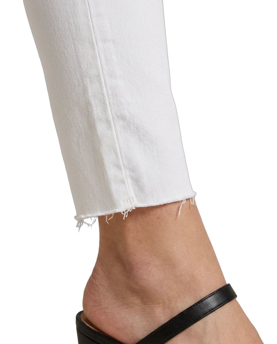 Close-up of a foot wearing a black sandal with white jeans on a white background
