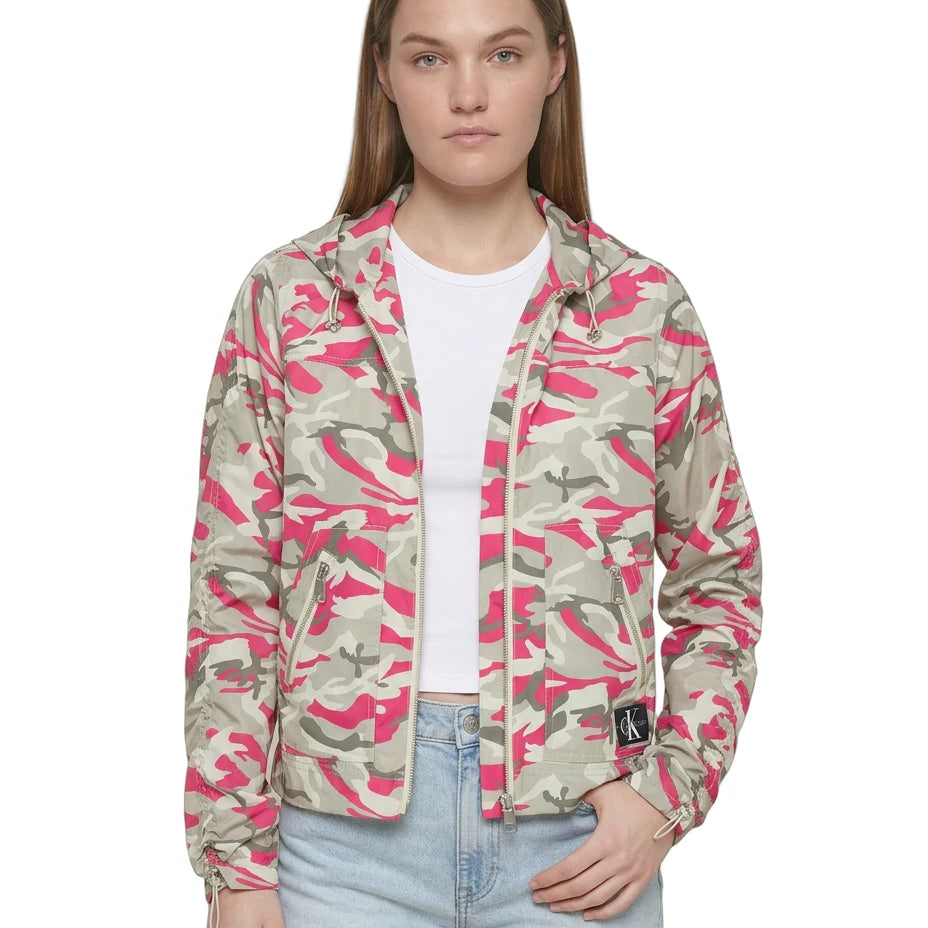 Person wearing a pink and green camouflage jacket on a white background