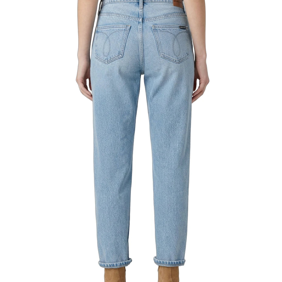 Light blue Calvin Klein jeans worn by a person on a white background