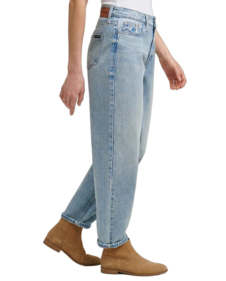 Light Calvin Klein blue jeans worn by a person on a white background