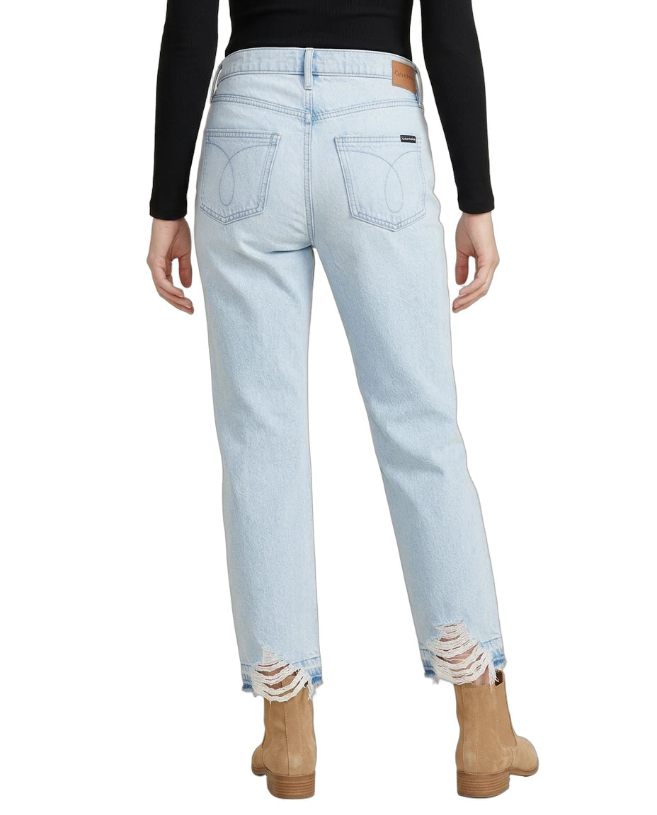 Light blue jeans with distressed hem worn by a person on a white background