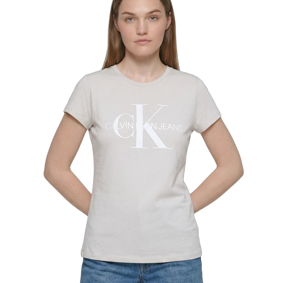 Person wearing a Calvin Klein t-shirt and denim shorts on a white background