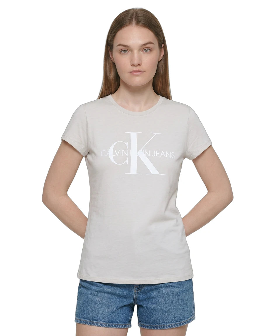 Person wearing a Calvin Klein t-shirt and denim shorts on a white background