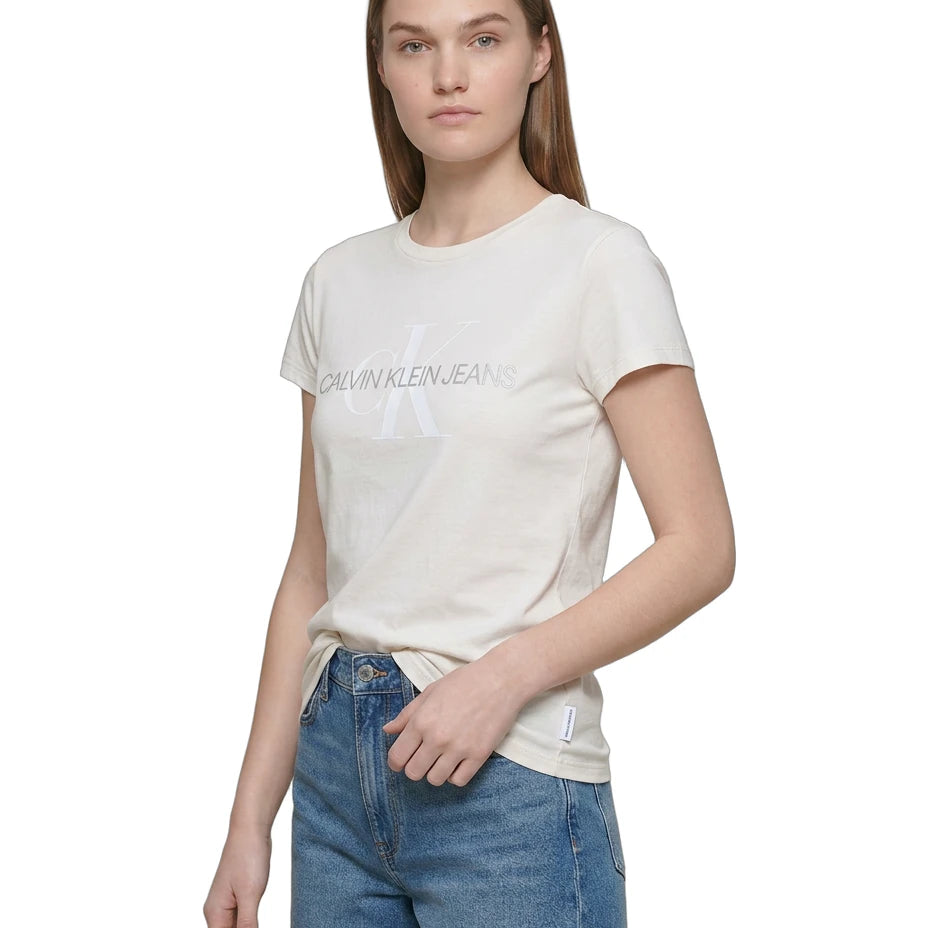 Woman wearing a Calvin Klein white t-shirt and denim shorts on a white background