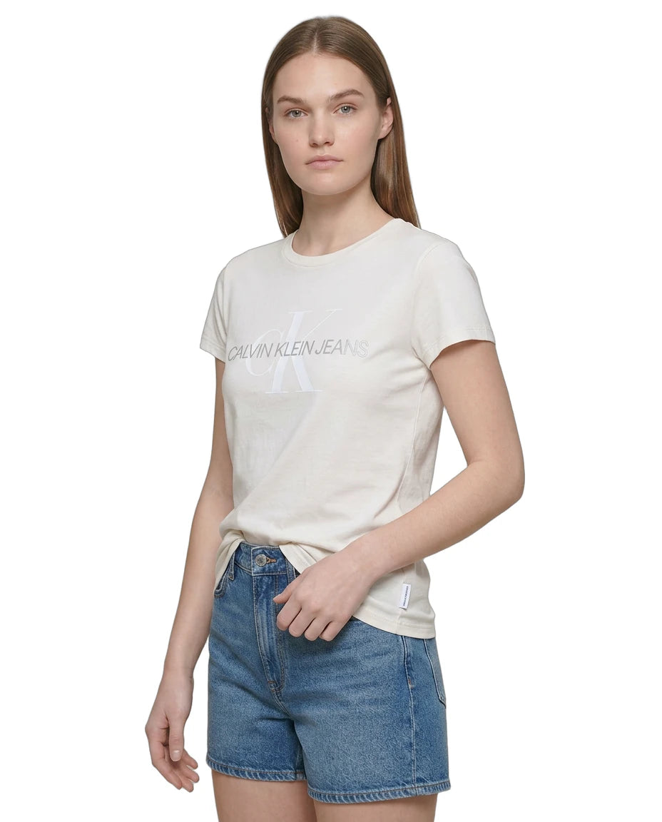 Woman wearing a Calvin Klein white t-shirt and denim shorts on a white background