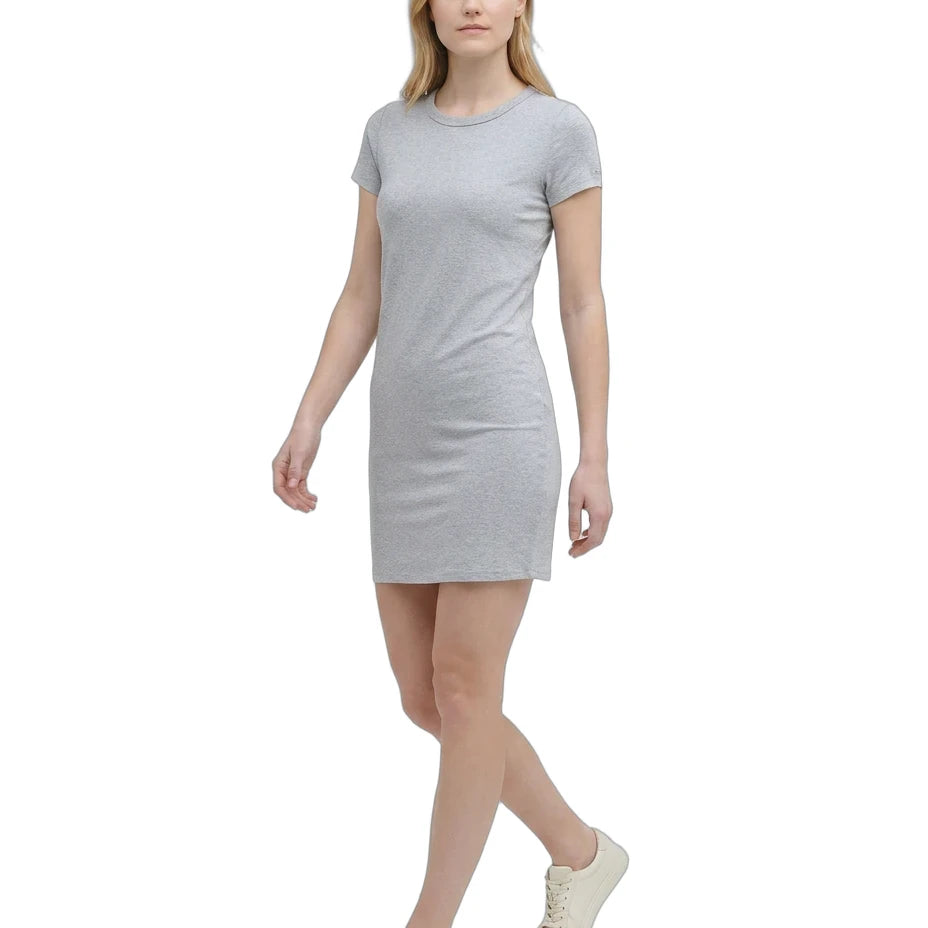 Woman wearing a gray Calvin Klein t-shirt dress on a white background