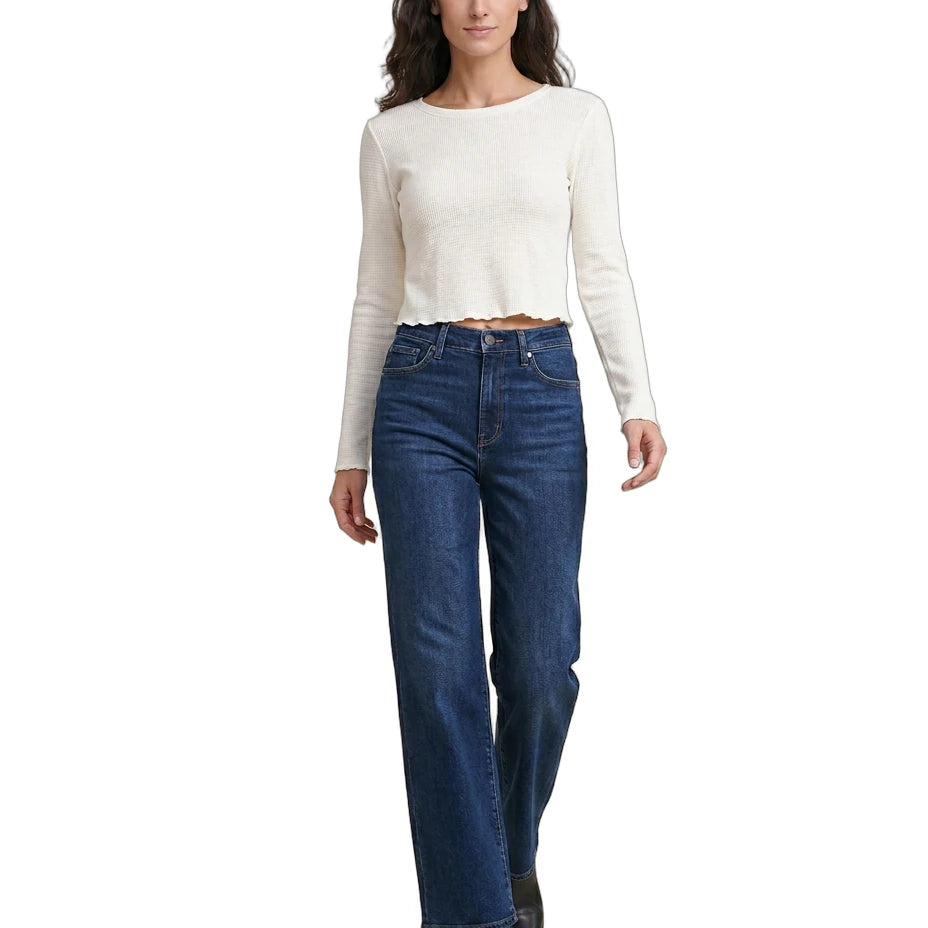 Woman wearing a white long-sleeve top and blue jeans on a white background