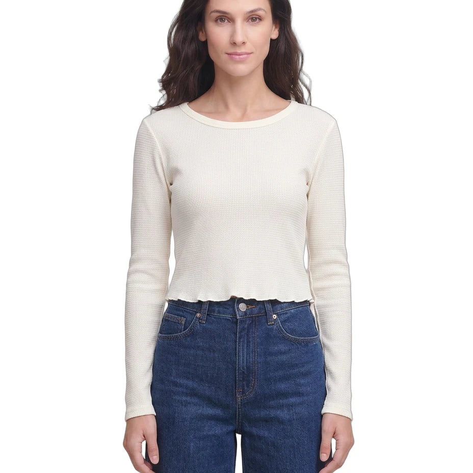 Woman wearing a white long-sleeve top and blue jeans on a white background