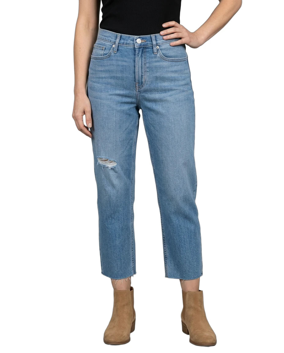 Person wearing light blue jeans with a white background