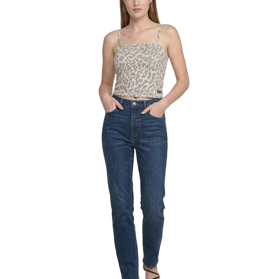 Woman wearing a leopard print top and blue jeans on a white background