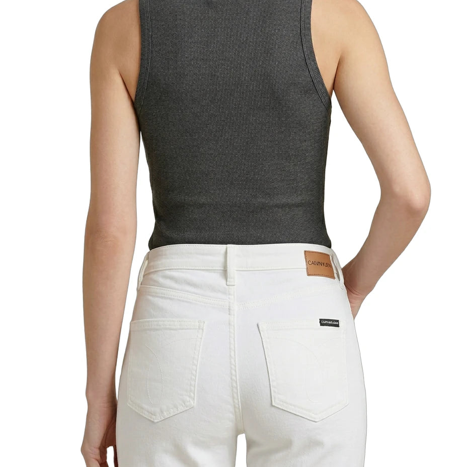Person wearing a gray tank top and white pants on a white background