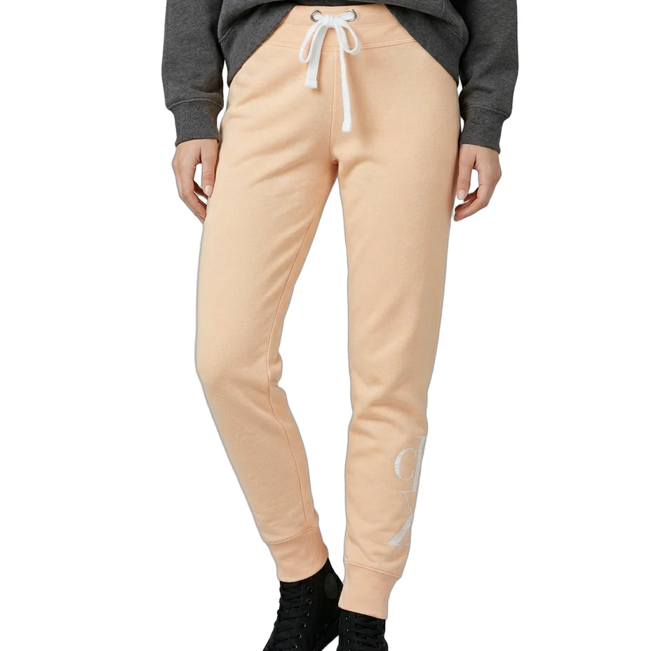 Person wearing beige jogger pants with a gray sweatshirt on a white background