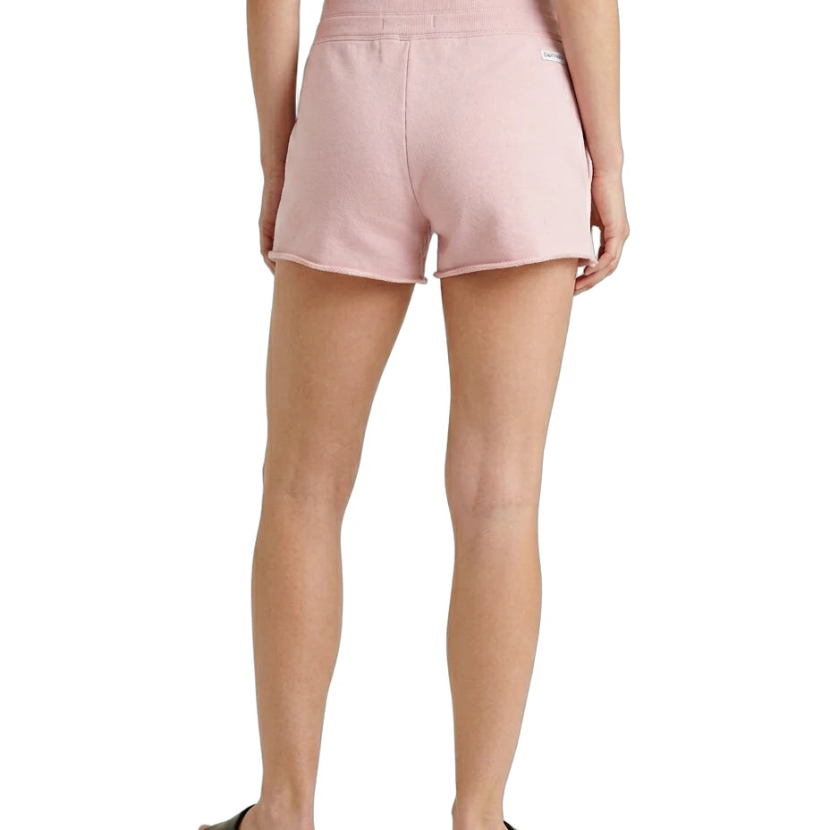 Person wearing pink shorts on a white background