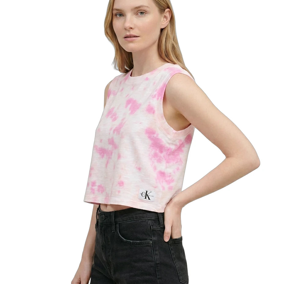 Woman wearing a pink tie-dye tank top with a brand logo on a white background