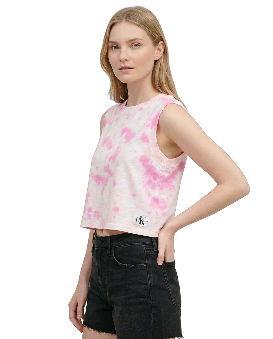 Woman wearing a pink tie-dye tank top with a brand logo on a white background